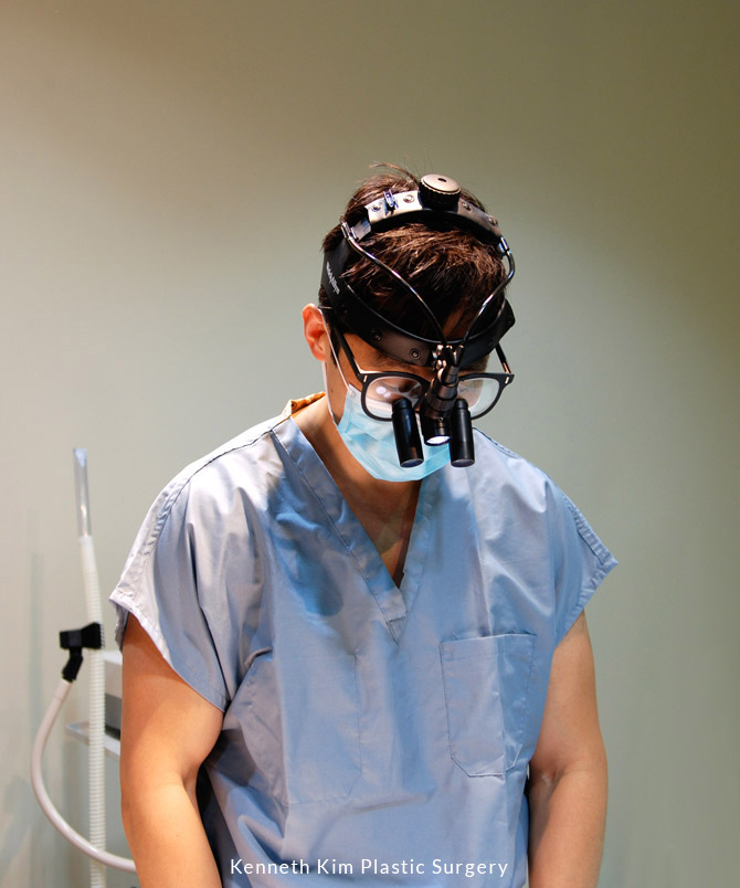 Dr. Kim wearing eye loops and looking downward